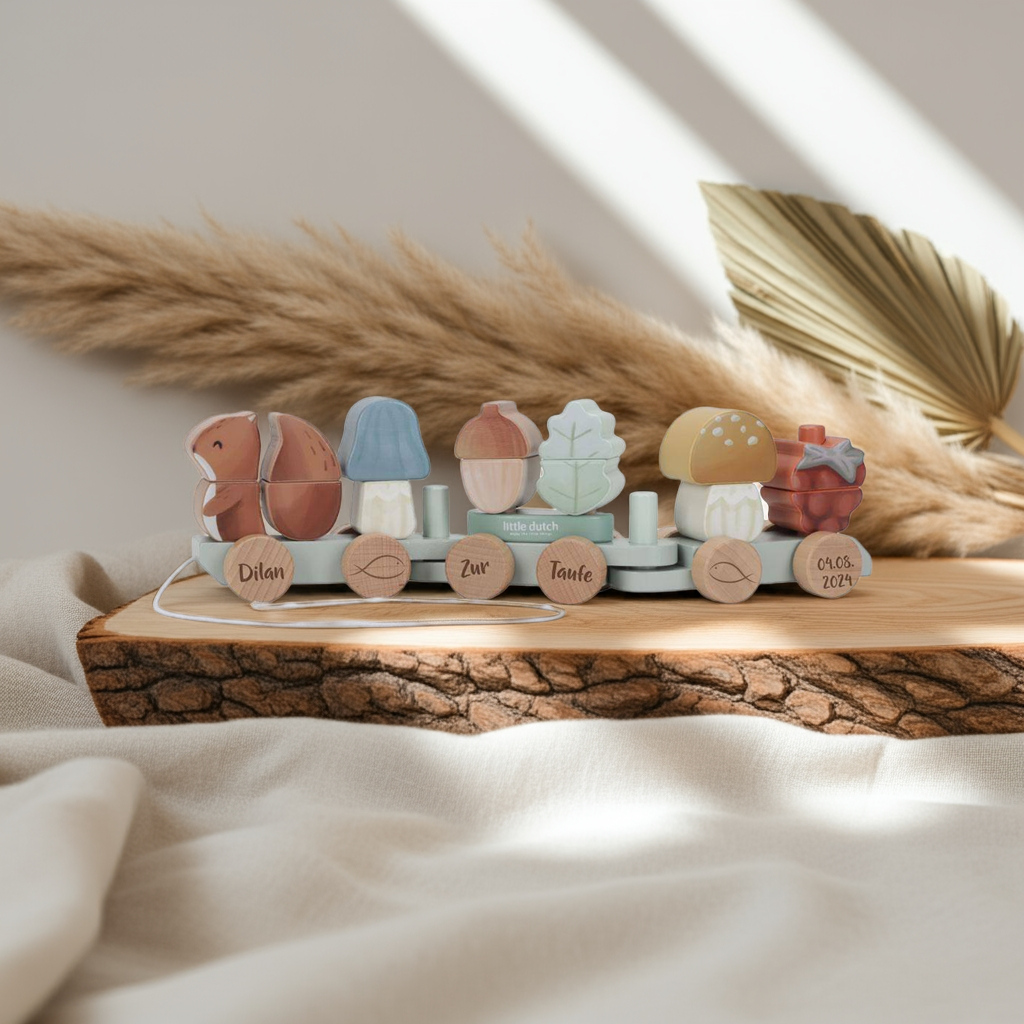 The Holz-Zug Eichhörnchen Forest Friends "Zur Taufe" by Little Dutch features pastel animal and plant shapes, personalized name plates, and sits on a soft, natural background with pampas grass.